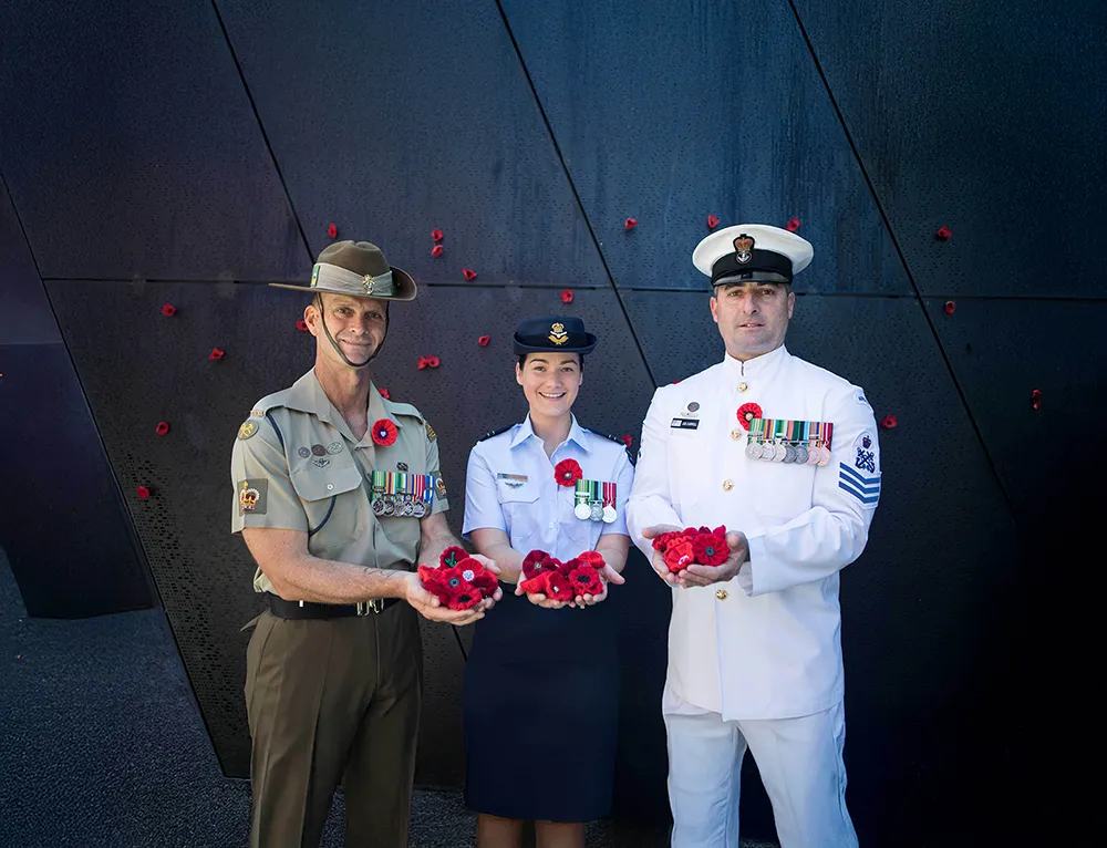 Veterans holding poppies